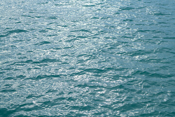 Abstract blue sea water. Background texture. Water in swimming pool or sea. Rippled water detail background. Blue sea surface.