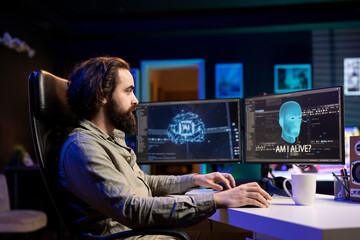 Computer scientist in apartment programming sentient artificial intelligence with own autonomy,...