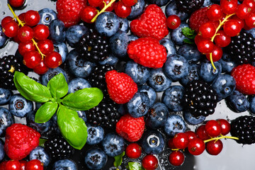 Wild berries. Ripe blackberries, blueberries, raspberries. Mix of garden berries. Forest fruit berry mix. Texture background. Ripe berries background.