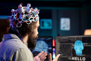 Software developer using EEG headset device translating thoughts into PC commands using brainwave...