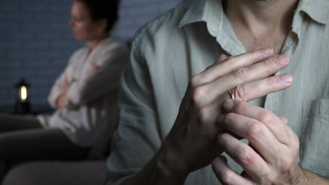 Husband take off couple ring. A view of husband takes off his ring after conflict with his wife indoor.