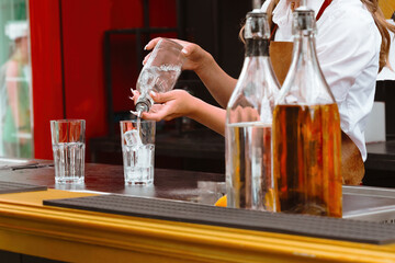 Bartender Pouring Drink Into Glass, Making Cocktail