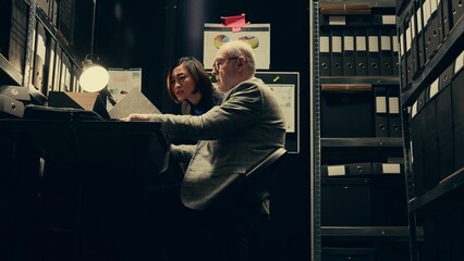 Investigators studying historical maps of crime scenes using federal classified records, officers...