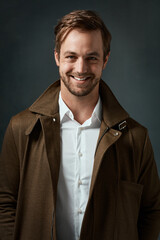 Studio, smile and man in portrait for fashion, winter style and vintage jacket with confidence for inspiration. Gray background, male model and pride for retro outfit, seasonal trend and cool guy