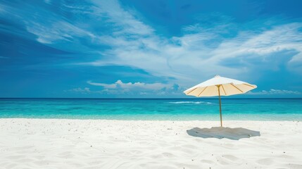Sandy beach with white sand blue sky and umbrella