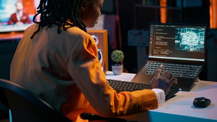 African american girl uses artificial intelligence software for machine learning and cloud computing, terminal window programming language. IT student studying deep learning AI hardware. Camera A.