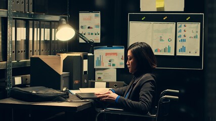 Detective with impairment studying classified folders in archive room, gathering information from...