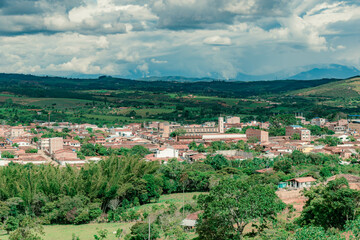 Fototapeta premium Landscape with cultivated plains and the municipality of Villanueva, Santander, Colombia.