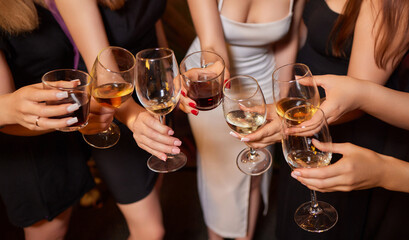 At a lively nightclub, people are enjoying wine and socializing in a chic ambiance