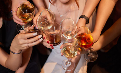 At a lively nightclub, people are enjoying wine and socializing in a chic ambiance