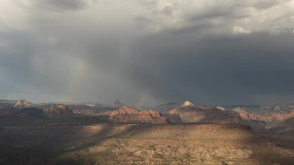 4k time lapse video of a summer thunderstorm and the formation of rainbows in the curtains of rain that passed over the mountains of Zion Nat. Park in Southern Utah, USA on July 20th 2024.