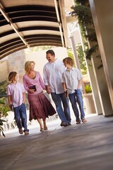 Family Walking With Bibles To Church
