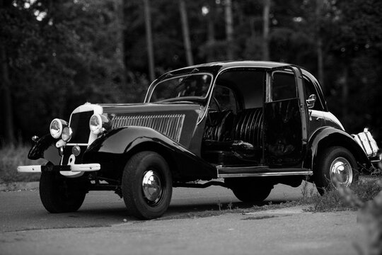 Fototapeta black vintage car with an open door. black and white photo