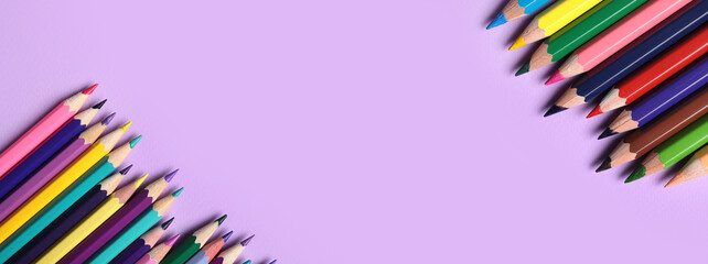 Different pencils on purple background, closeup
