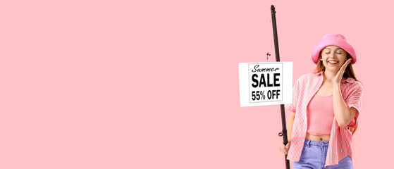 Happy young woman with fishing rod and SALE sign on pink background. Concept of discount