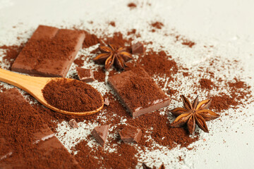 Tasty chocolate pieces, coffee powder and anise stars on light background, closeup