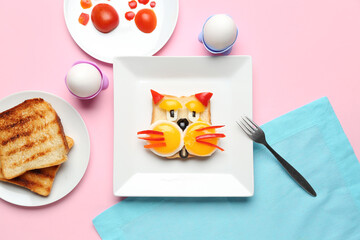 Plate with funny breakfast in shape of cat, toasts and vegetables on pink background