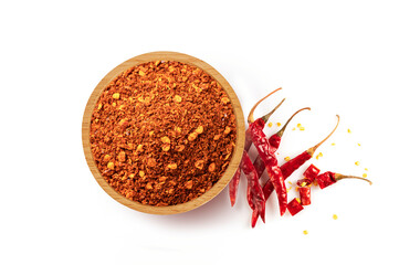 Red hot chili powder in wooden bowl 
and red chili isolated on white background. Top view
