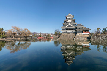Matsumoto, Japan - December 25, 2023: Matsumoto Castle, view with reflection. One of Japan's...