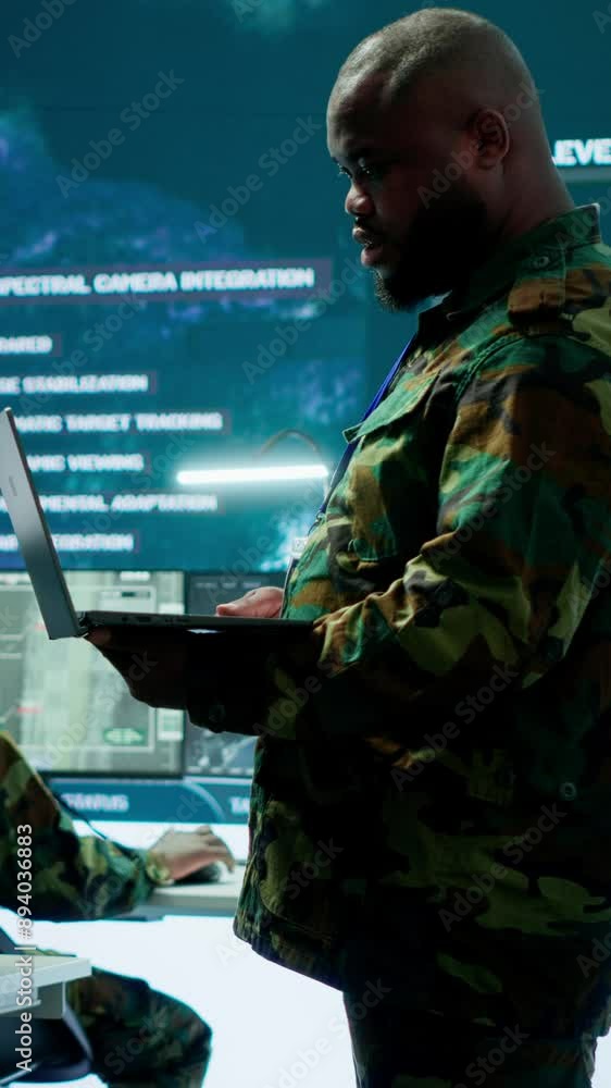 Poster Vertical Video Cybersecurity team operates in an advanced military command center, surveillance systems and data protection. Army personnel work on national security operations using high tech gear