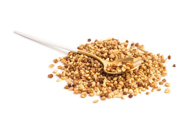 Spoon with raw buckwheat grains on white background