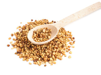 Wooden spoon with raw buckwheat grains on white background