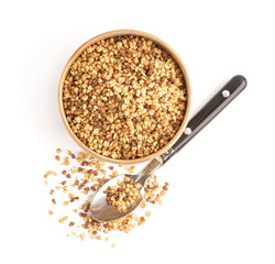 Bowl and spoon with raw buckwheat grains on white background