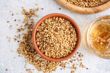 Glass of fresh buckwheat tea on light background, closeup