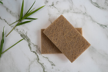Top view of two eco-friendly sponges on marble surface