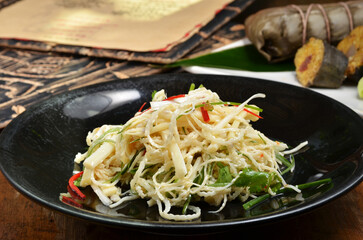 Areca flower salad on black plate 