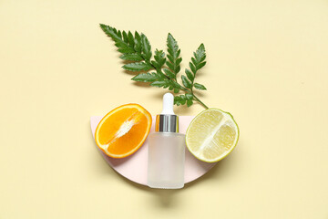 Composition with pieces of citrus fruits, fern twig, plaster stand and bottle of cosmetic product...
