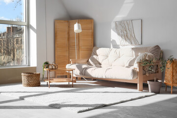 Interior of living room with cozy sofa, lamp, window and coffee table