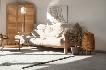 Interior of living room with cozy sofa, lamp, window and coffee table