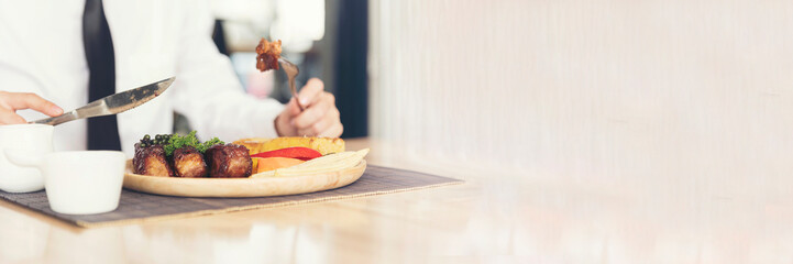 Banner Top view Businessman hands eat Ribs eye Steak lunch at restaurant. Banner Men hands steak cutting meat enjoy eating salad cream French fries Barbecue Grill Meat beef beefsteak with copy space