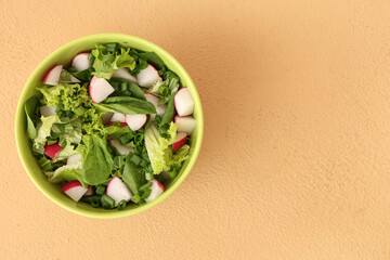 Bowl of tasty salad with radish on color background