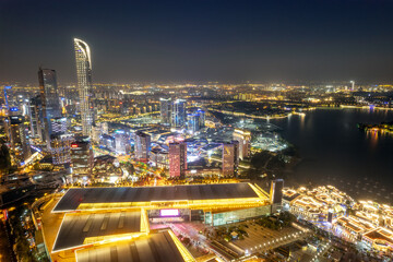 Fototapeta premium Vibrant Urban Nightscape: City Lights and Reflections on Water