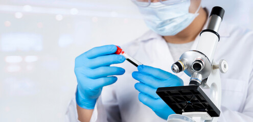 Fototapeta premium Technician holding blood tube test in the research laboratory. Development research in laboratory.