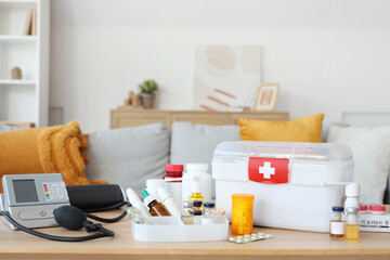 Home first aid kit with medications on table in room