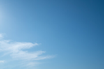 Fototapeta premium Expansive Clear Blue Sky with Soft White Clouds