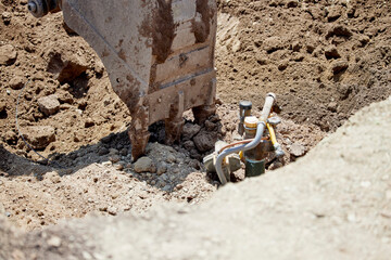 An excavator digging out a buried propane tank