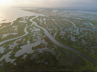 The sun rises along Beach Road and the Matagorda Bay the day after Hurricane Beryl brought deadly...