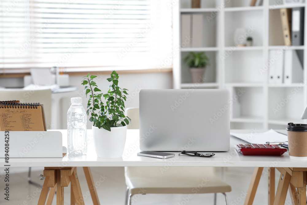 Canvas Prints Interior of stylish office with workplaces, laptop and shelving unit