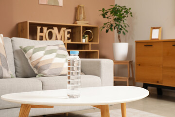 Bottle of water on table in living room