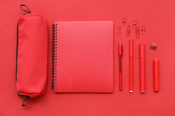 Composition with red stationery on color background
