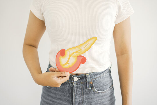 Woman hands holding pancreas, pancreatitis and pancreatic cancer concept