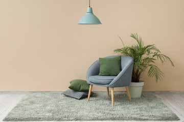 Interior of living room with green carpet, armchair and palm tree