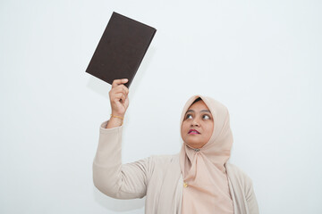 A beautiful woman is holding a book inside the office