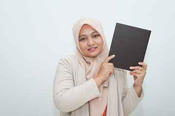 A beautiful woman is holding a book inside the office