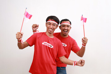 Happy excited Two Indonesian men holding red white flag to celebrating Indonesia independence day