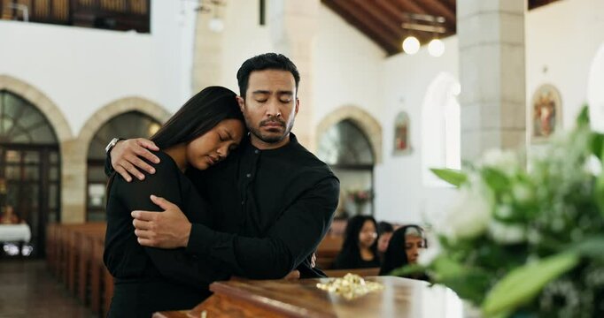 Death, loss or couple at funeral by coffin, mourning or man to comfort woman for dead family. Grief, support and people grieving together by wooden casket and sadness at remembrance service in church